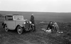 Three women having a picnic during a road test of a Triumph Scorpion, 1931. Artist: Bill Brunell