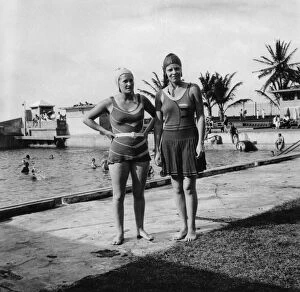 Hands On Hips Gallery: Two women in swimsuits beside a swimming pool, Balboa, Panama, 1931