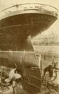Liner Gallery: At Work on the Stern of the Mauretania, in Dry Dock, c1930. Creator: Unknown