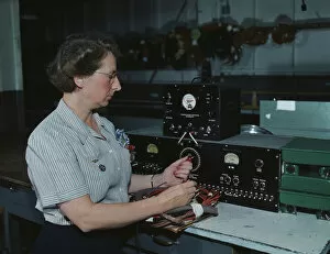 Machine Collection: Working with the electric wiring at Douglas Aircraft Company, Long Beach, Calif. 1942