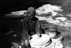 Flour Prints: Working with a flour millstone, 1890. Creator: Unknown
