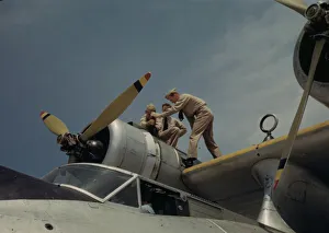 Aeronautics Gallery: Working on a plane at the Naval Air Base, Corpus Christi, Texas, 1942. Creator: Howard Hollem