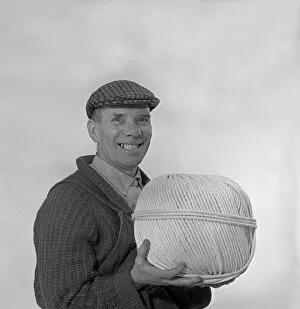 String Gallery: Yorkshireman wearing a flat cap and holding a large ball of twine, 1968