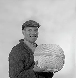 String Prints: Yorkshireman wearing a flat cap and holding a large ball of twine, 1968