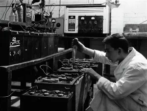 Motor Maintenance Gallery: A young apprentice at Globe & Simpson auto electricians workshop, Lincoln, Lincolnshire, 1961