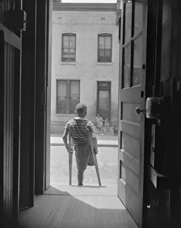 Doorway Collection: Young boy standing in the doorway of his home on Seaton Road... Washington, D.C, 1942