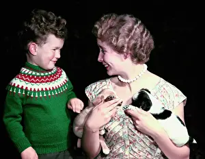 Happy Prints: Young boy and woman holding two puppies, c1955-1965. Creator: Arthur Charles Kirby Ware