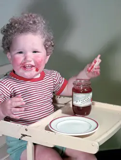 Happy Prints: Young child eating P Hartley's Red Plum Jam and bread