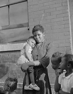 Childcare Collection: Young girl with her sister who live on Seaton Road, Washington, D.C. 1942. Creator: Gordon Parks
