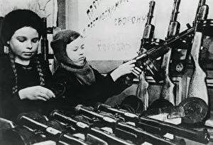 War Work Gallery: Young girls assembling machine guns in a Russian factory, 1943