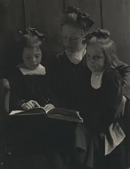 Kasebier Gertrude Prints: Three young girls reading a book, c1900. Creator: Gertrude Kasebier
