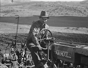 Cooperative Gallery: Young Idaho farmer plowing...Ola self-help sawmill co-op... Gem County, Idaho, 1939