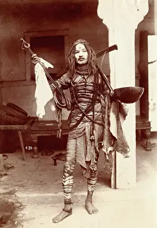 Face Paint Prints: A young Indian man wearing many beads and makeup in a temple precinct