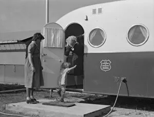 Refugee Camp Gallery: Young mother brings her child to the trailer clinic... FSA, Merrill, Klamath County, Oregon, 1939