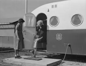 Displaced Persons Collection: Young mother brings her child to the trailer clinic... FSA, Merrill, Klamath County, Oregon, 1939