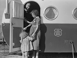 Young mother brings her child to the trailer clinic... FSA, Merrill, Klamath County, Oregon, 1939. Creator: Dorothea Lange