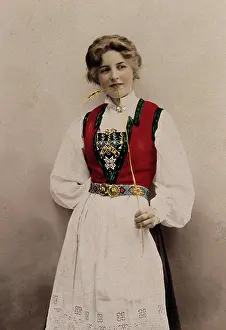 Flirting Prints: A young Norwegian woman, posing in a photographic studio wearing peasant dress