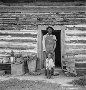 Cabin Gallery: Young sharecropper and his first child, Hillside Farm, Person County, North Carolina, 1939