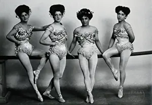 Troupe Prints: Four young woman acrobats (?), posing on a bar in a photographic studio