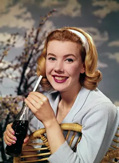 Thirsty Prints: A young woman drinking a bottle of Coca-Cola, c1955. Creator: Arthur Charles Kirby Ware