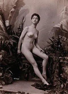 Defiance Prints: A young woman seated on a low balustrade posing naked, c1900. Creator: Unknown