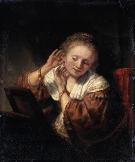 Trying On Prints: Young Woman trying on Earrings, 1657. Artist: Rembrandt Harmensz van Rijn