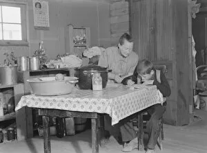 Dug Out Gallery: The youngest Wardlow boy copies out a recipe for his mother, Dead Ox Flat, Oregon, 1939