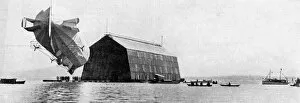 A Zeppelin entering its floating shed, c 1900, (c1920)