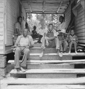 Step Gallery: Zollie Lyon, Negro sharecropper, home from the field for dinner... Wake County, North Carolina