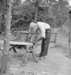 Repair Prints: Zollie Lyons repairing the tobacco sleds
